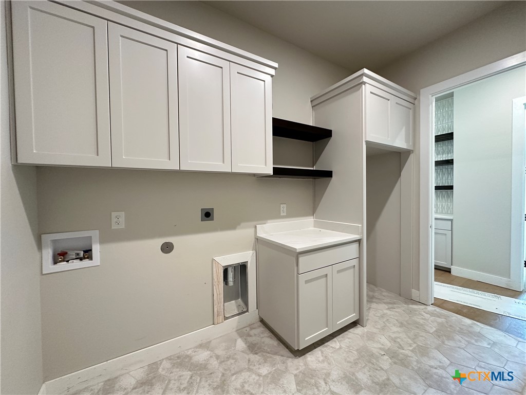 418 Dos Rios Drive Belton, TX 76513 - Photo 28 of 41 a view of cabinets with washer and dryer