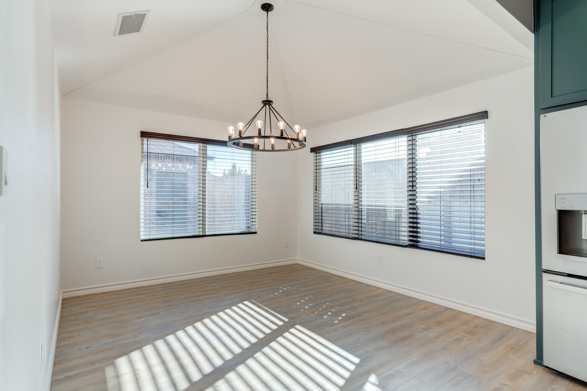 12701 Kenosha Avenue Lubbock, TX 79423 - Photo 29 of 61 a view of an empty room with a window and a kitchen view