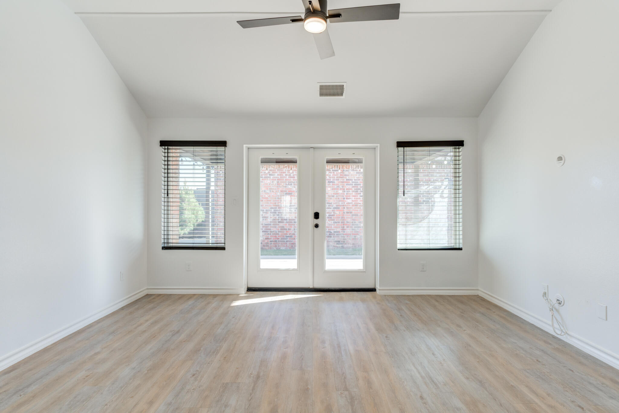 12701 Kenosha Avenue Lubbock, TX 79423 - Photo 31 of 61 an empty room with wooden floor and windows