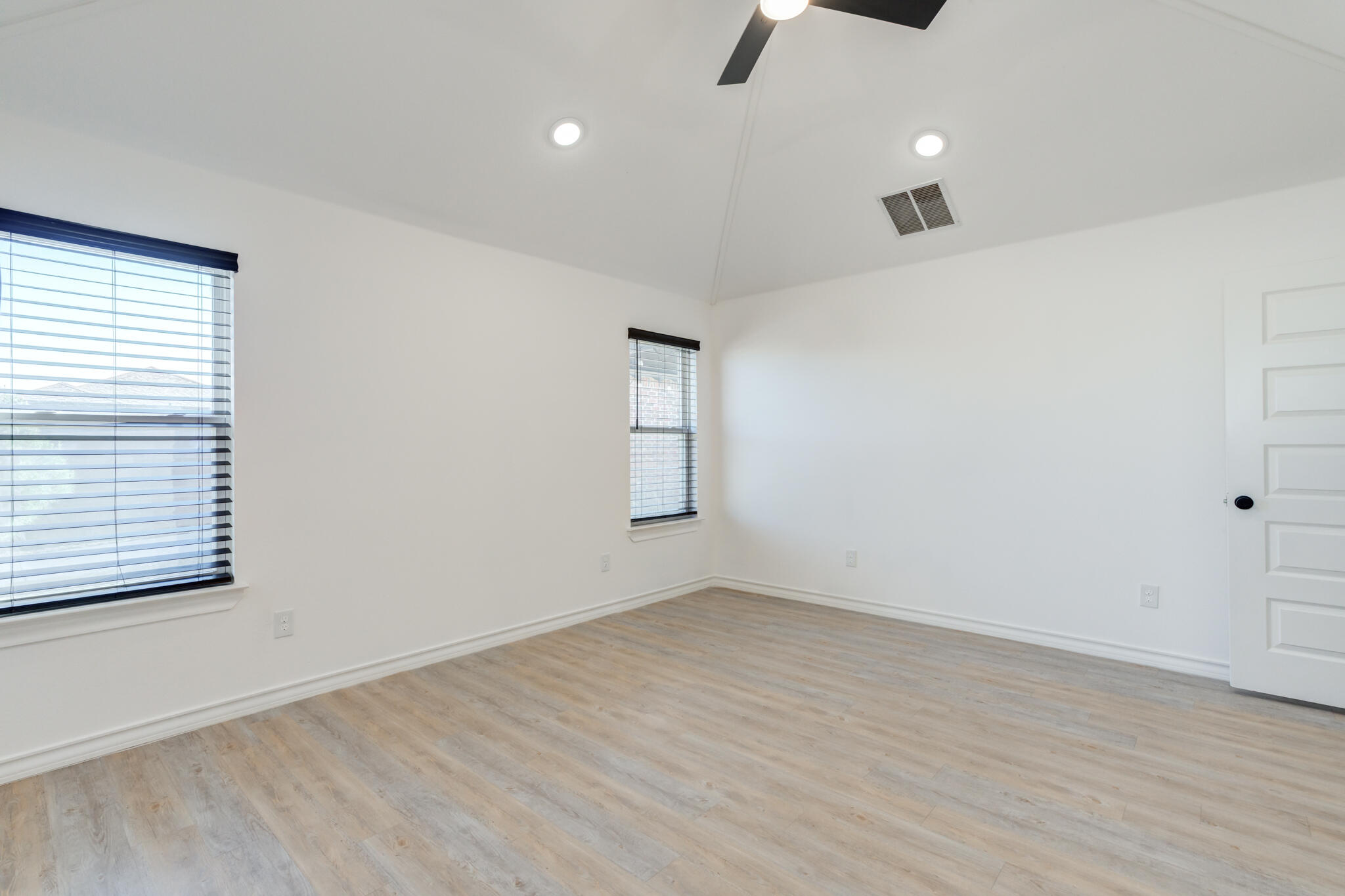 12701 Kenosha Avenue Lubbock, TX 79423 - Photo 34 of 61 an empty room with wooden floor cabinet and windows