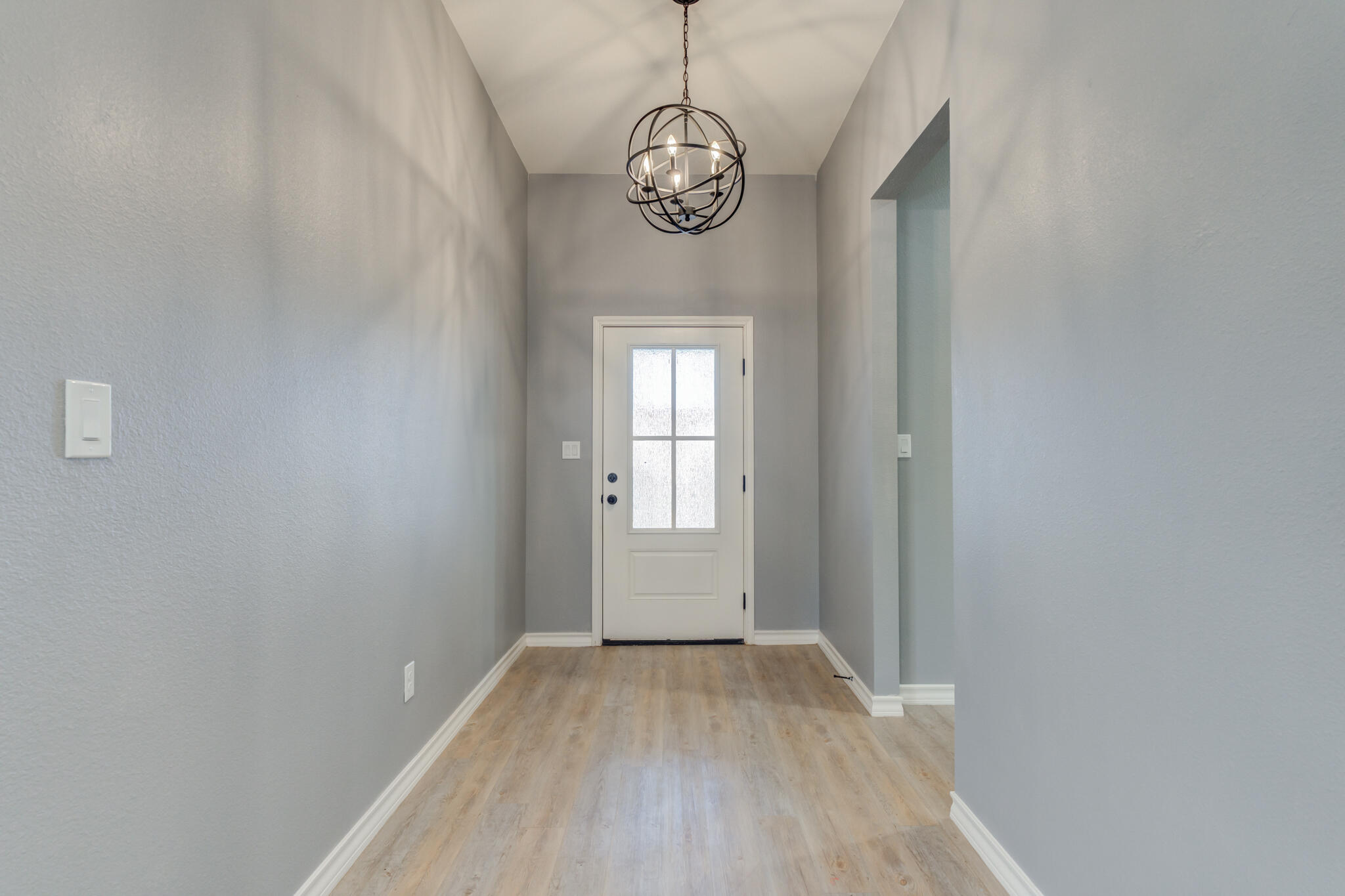 12701 Kenosha Avenue Lubbock, TX 79423 - Photo 7 of 61 a view of a hallway with windows and chandelier