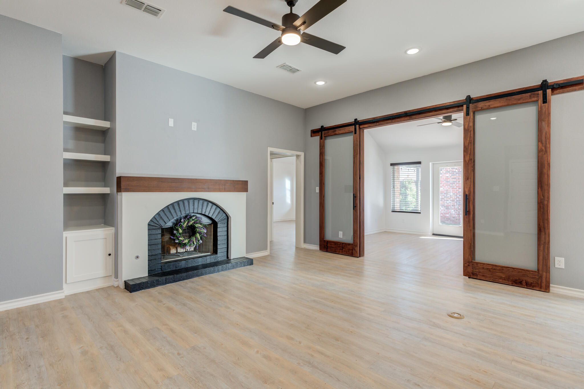 12701 Kenosha Avenue Lubbock, TX 79423 - Photo 10 of 61 an empty room with windows and fireplace
