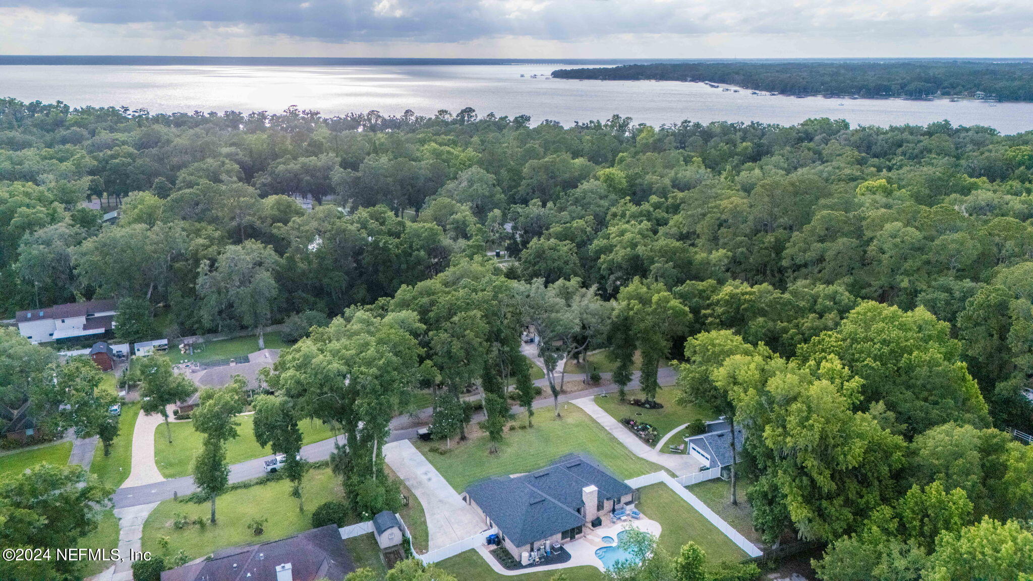 an aerial view of a city with lots of residential buildings and mountain view in back