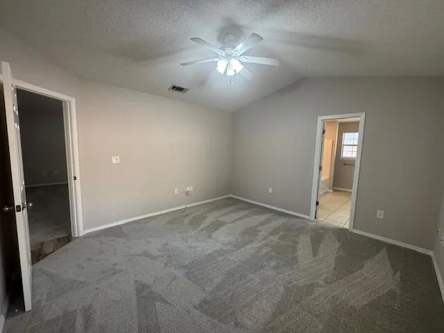 an empty room with closet and a chandelier fan