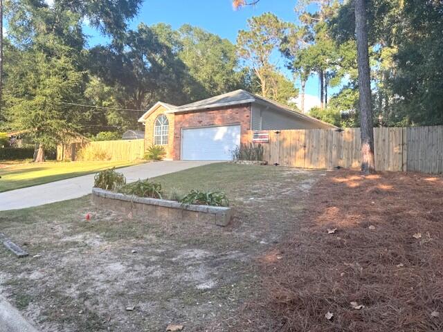 252 Panama Drive Crestview, FL 32536 - Photo 5 of 36 a view of a large house with a yard and large tree