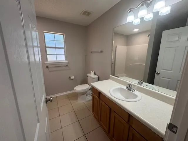 a bathroom with a sink a toilet a mirror and vanity