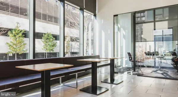 a living room with furniture wooden floor and a table