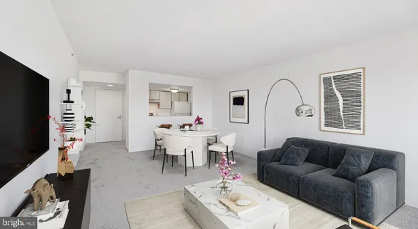 a living room with furniture a rug a flat screen tv and a window