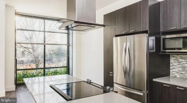 a kitchen with stainless steel appliances a refrigerator and a sink
