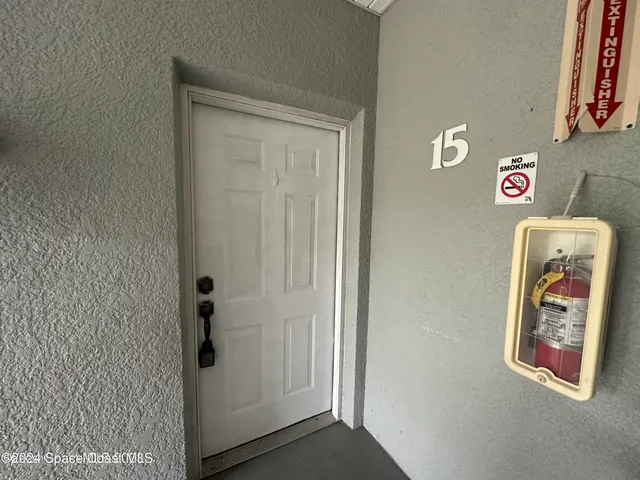 an empty room with windows and entrance