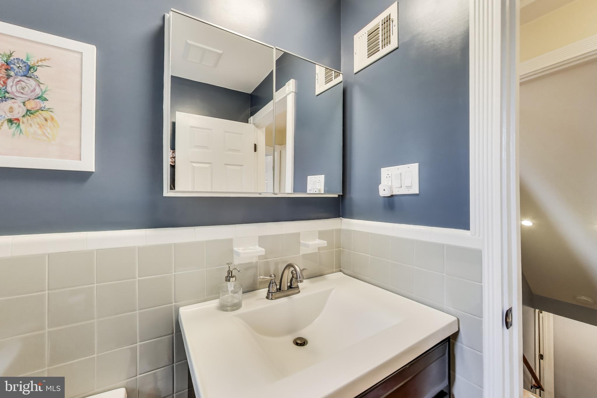 3316 Harrell Street Silver Spring, MD 20906 - Photo 15 of 38 a bathroom with a sink and a mirror