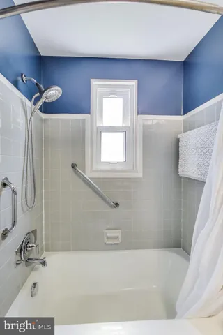 a bathroom with a bathtub and a shower