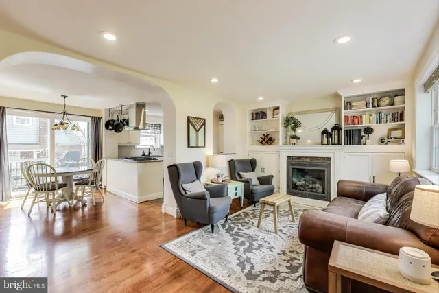 a living room with furniture wooden floor and a fireplace