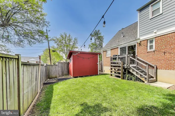 a view of a house with a yard and tree s