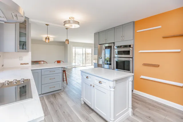 a kitchen with a sink stove and cabinets