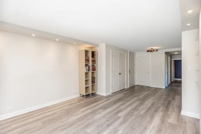 a view of a kitchen with furniture and wooden floor