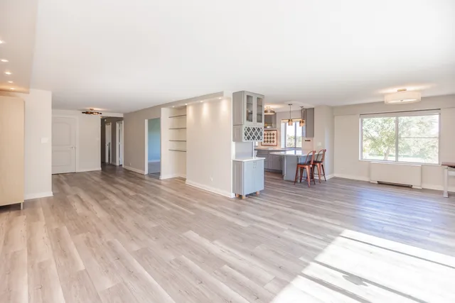 a view of a kitchen with kitchen island a sink wooden floor and a counter top space
