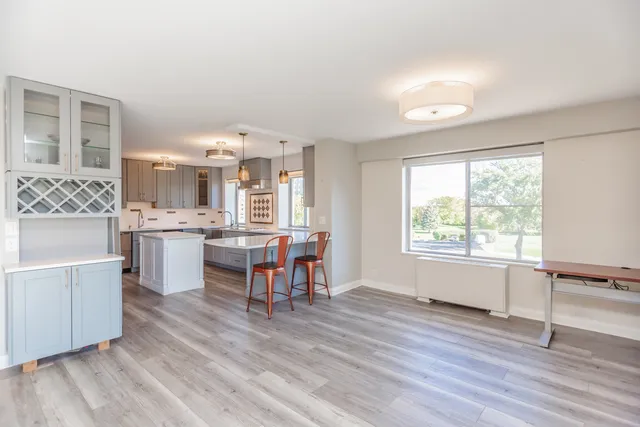 a view of kitchen with refrigerator microwave and wooden floor