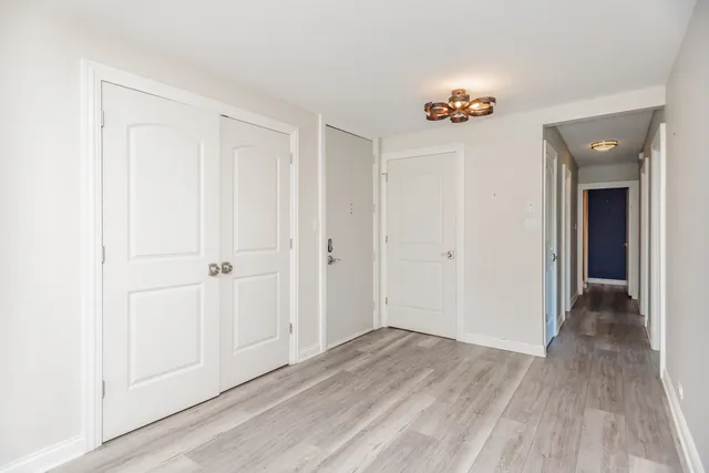 a view of an entryway with wooden floor