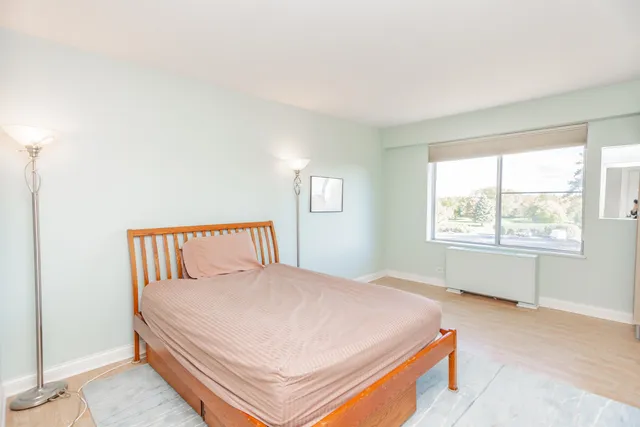 a bedroom with a bed and a night stand