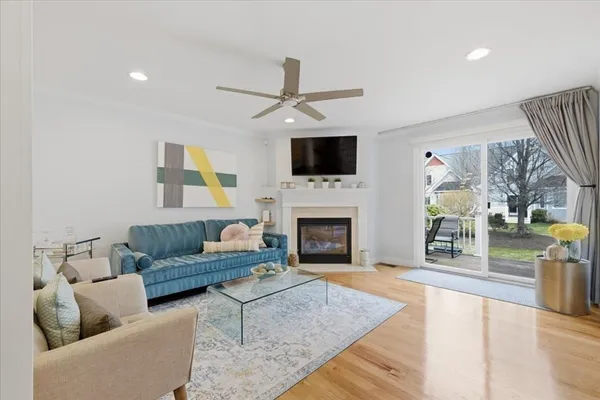 a living room with furniture a fireplace and a flat screen tv