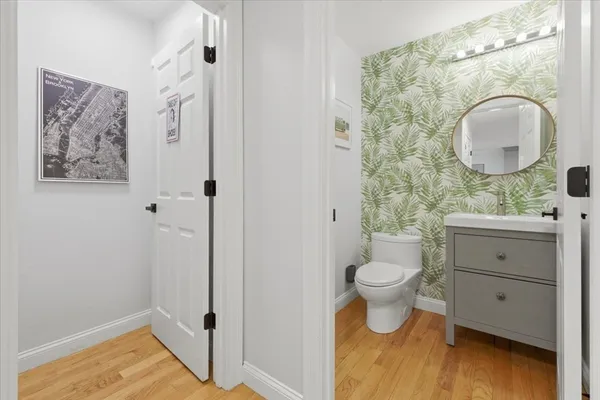 a bathroom with a toilet sink and mirror