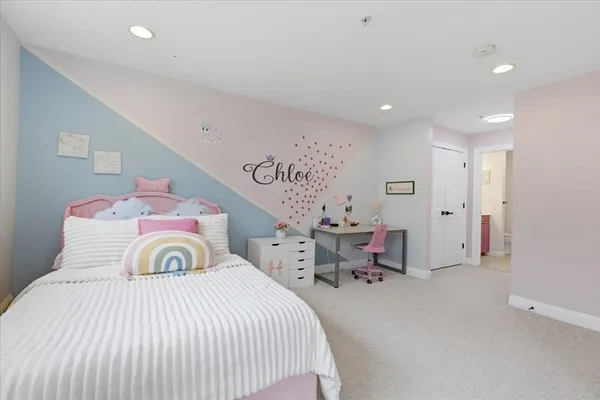 a bedroom with a bed and a chair
