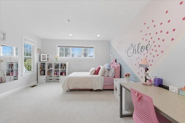a bedroom with furniture and a window