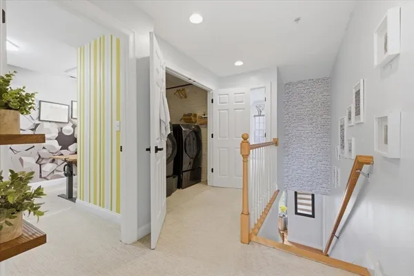 a view of a hallway with furniture and entryway