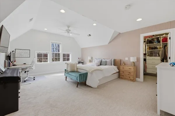 a spacious bedroom with a bed and a couch