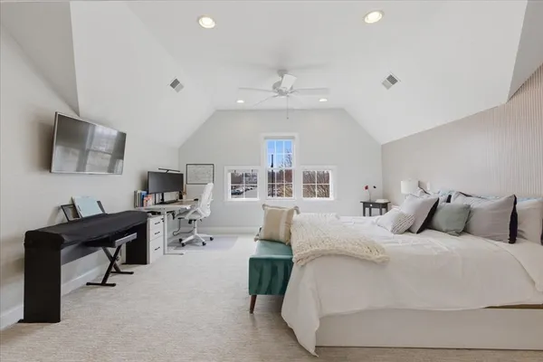 a bedroom with a bed window and a flat screen tv