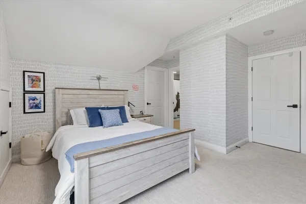 a bed room with a bed and a night stand