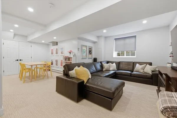 a living room with furniture and kitchen view
