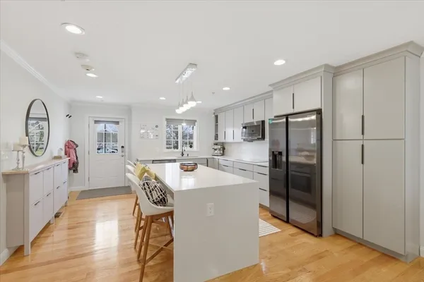 a kitchen with refrigerator and cabinets