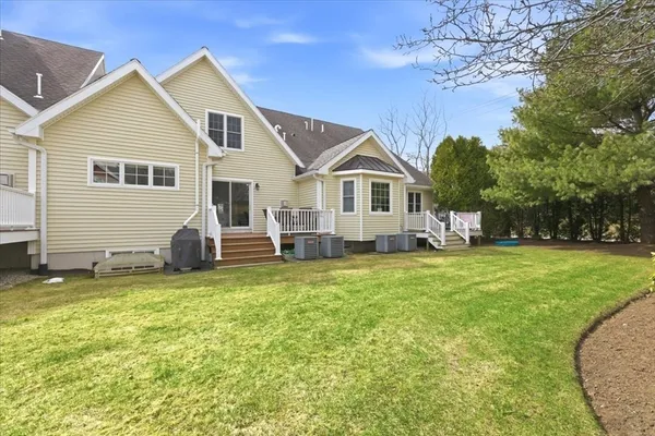 a view of a house with a yard patio and fire pit