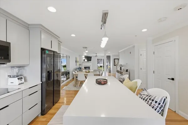 a large white kitchen with stainless steel appliances lots of counter top space