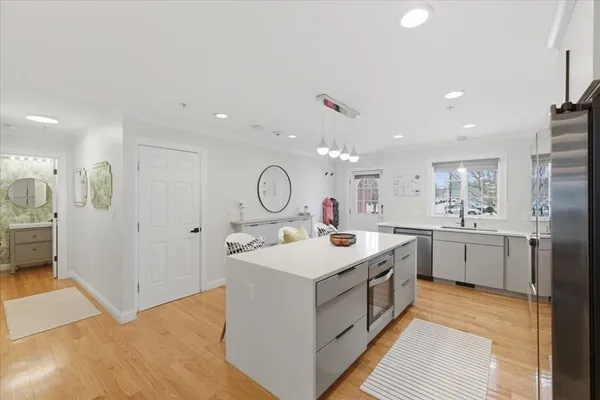 a view of a kitchen with a sink and refrigerator