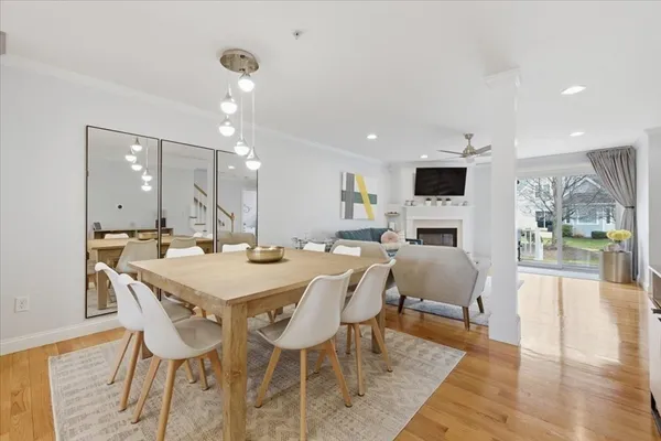 a view of a dining room with furniture wooden floor and a fireplace