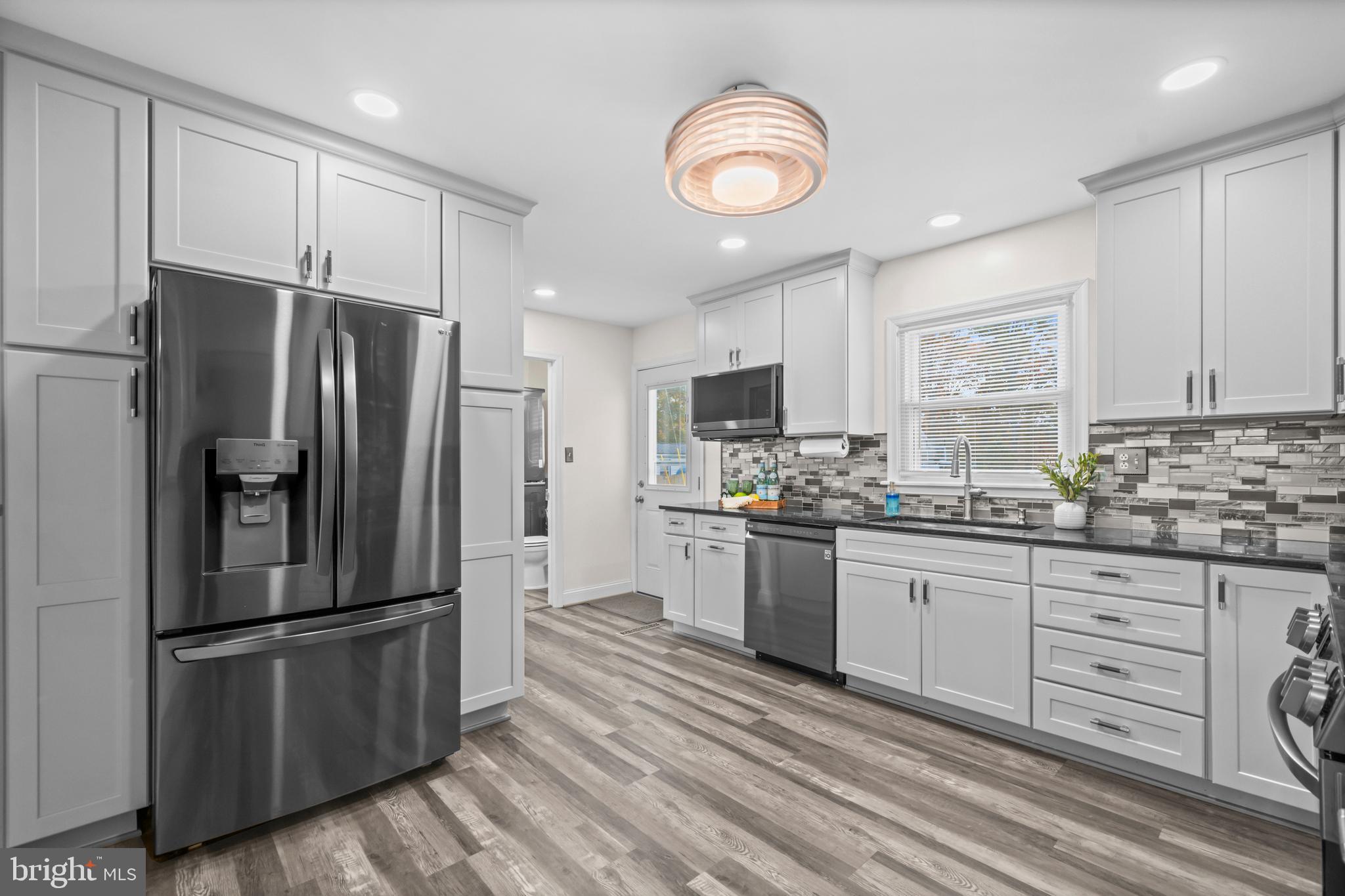 16203 Brandywine Road Brandywine, MD 20613 - Photo 12 of 37 a kitchen with granite countertop a refrigerator stove and sink