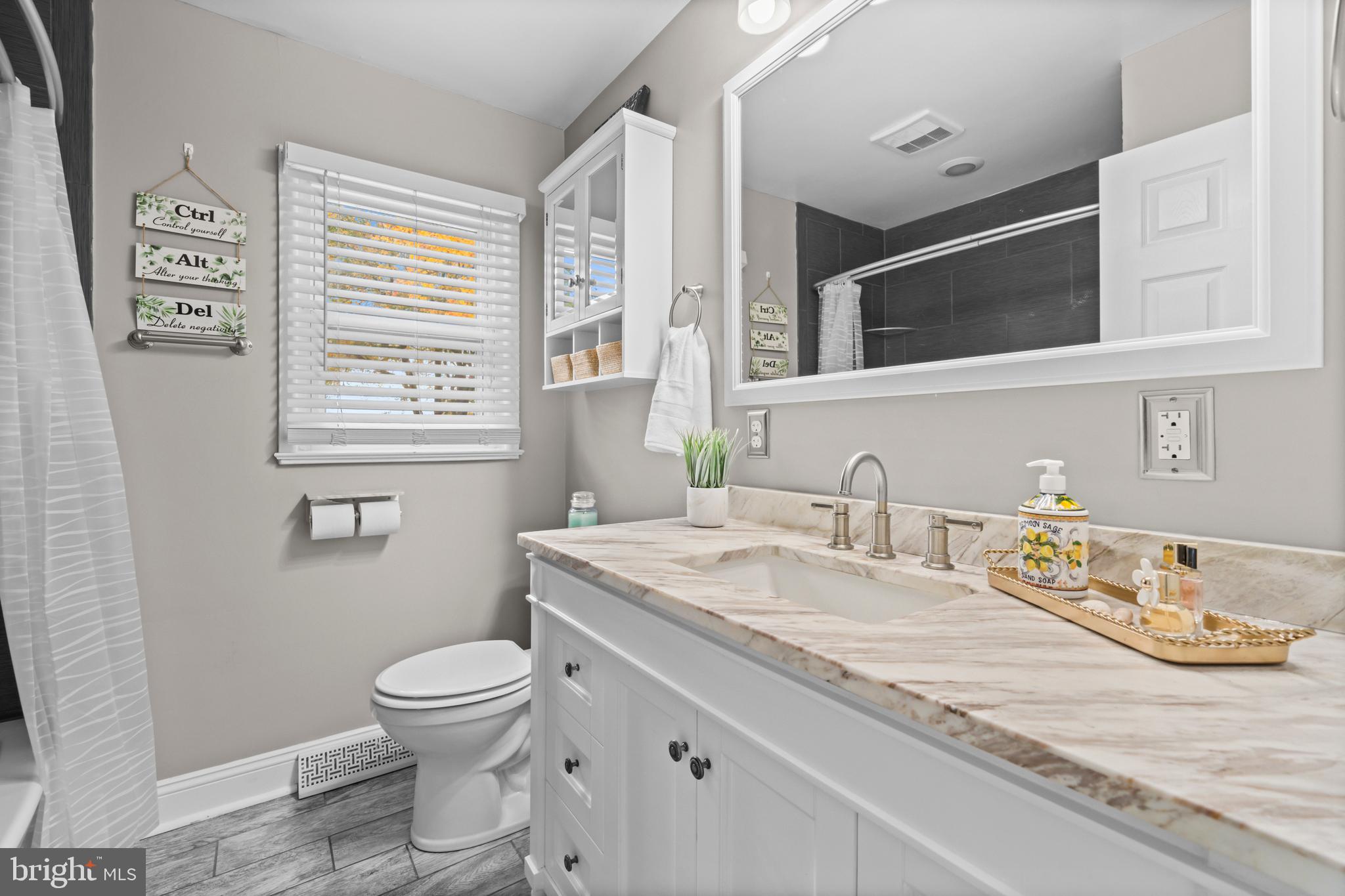 16203 Brandywine Road Brandywine, MD 20613 - Photo 21 of 37 a bathroom with a granite countertop toilet sink and mirror