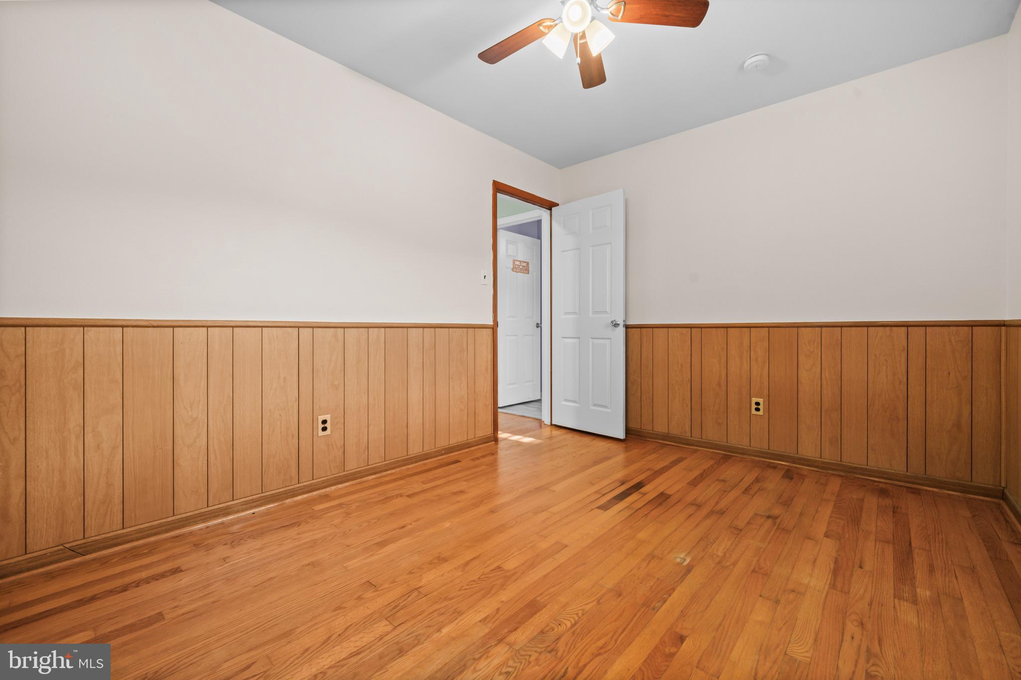 16203 Brandywine Road Brandywine, MD 20613 - Photo 25 of 37 an empty room with wooden floor chandelier fan and windows