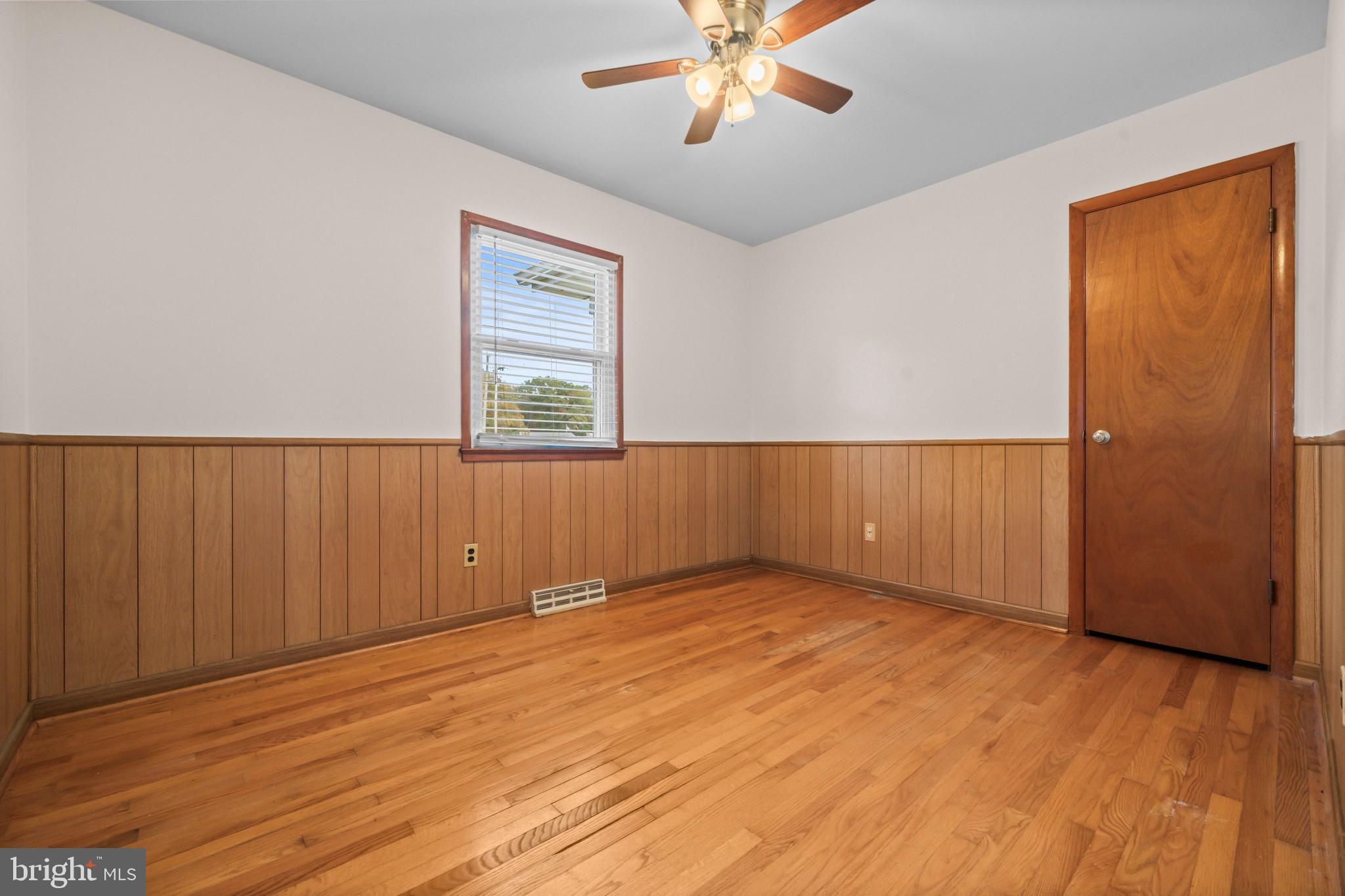 16203 Brandywine Road Brandywine, MD 20613 - Photo 26 of 37 an empty room with wooden floor fan and windows