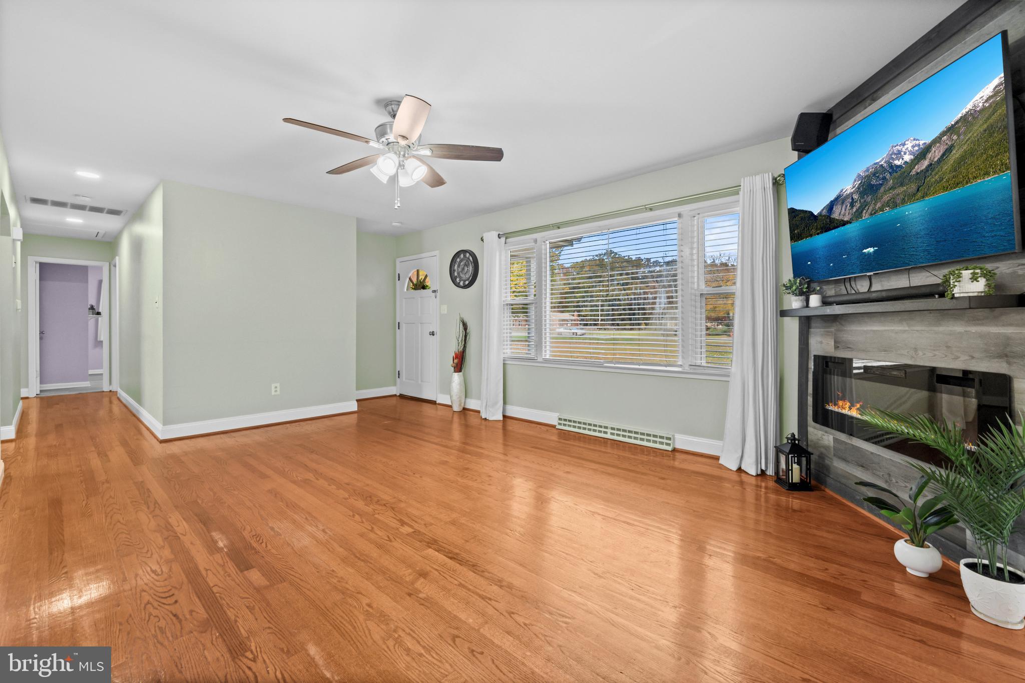 16203 Brandywine Road Brandywine, MD 20613 - Photo 6 of 37 a view of an empty room with a window and wooden floor