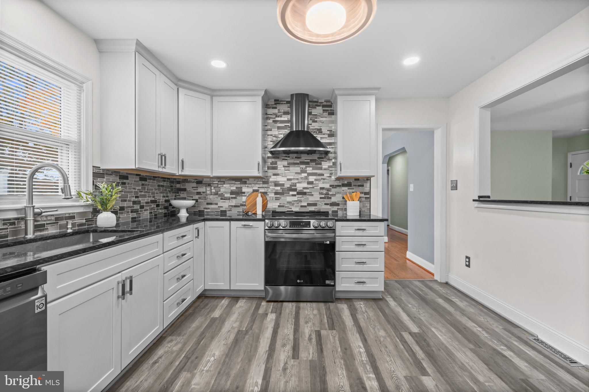 16203 Brandywine Road Brandywine, MD 20613 - Photo 10 of 37 a kitchen with kitchen island white cabinets and stainless steel appliances