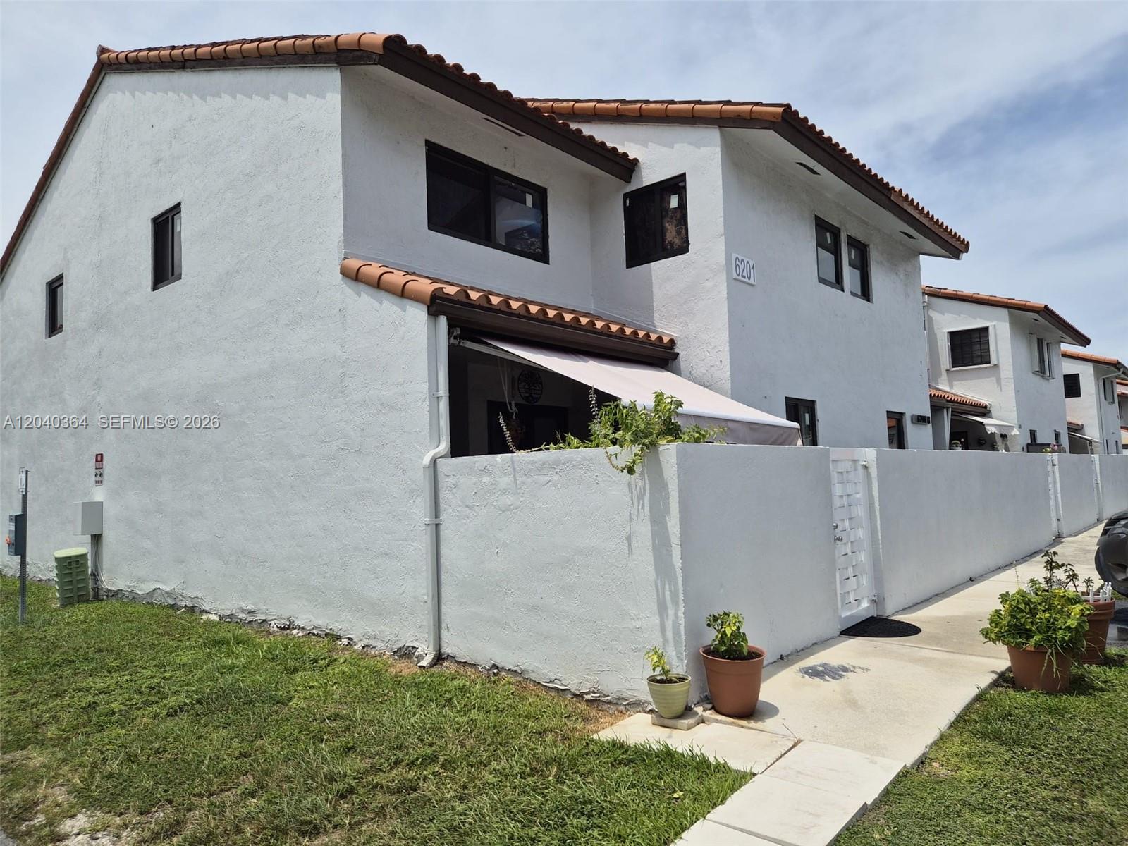 6201 Southwest 138th Court Miami, FL 33183 - Photo 2 of 7 a front view of a house with a yard