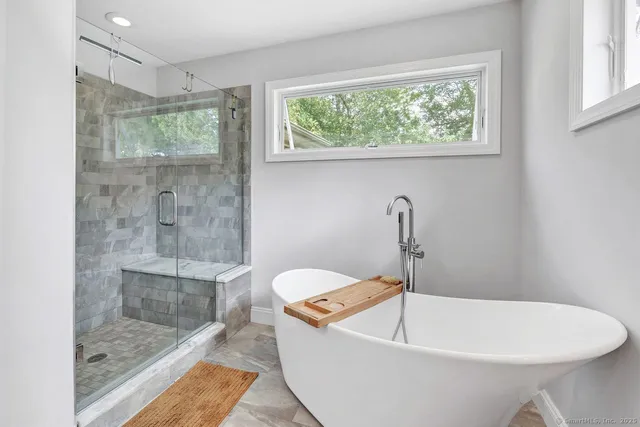 a white bath tub sitting next to a window