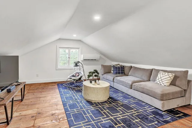 a living room with a couch and a potted plant