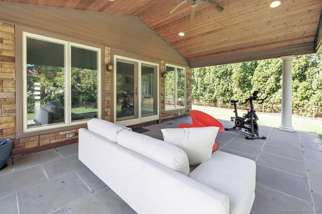 a living room with furniture and large windows