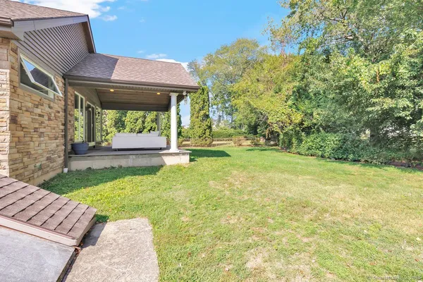 a view of backyard of house with green space