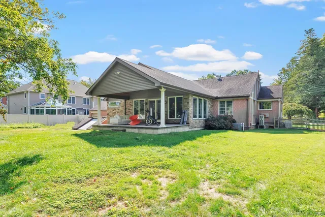 a view of an house with backyard and patio